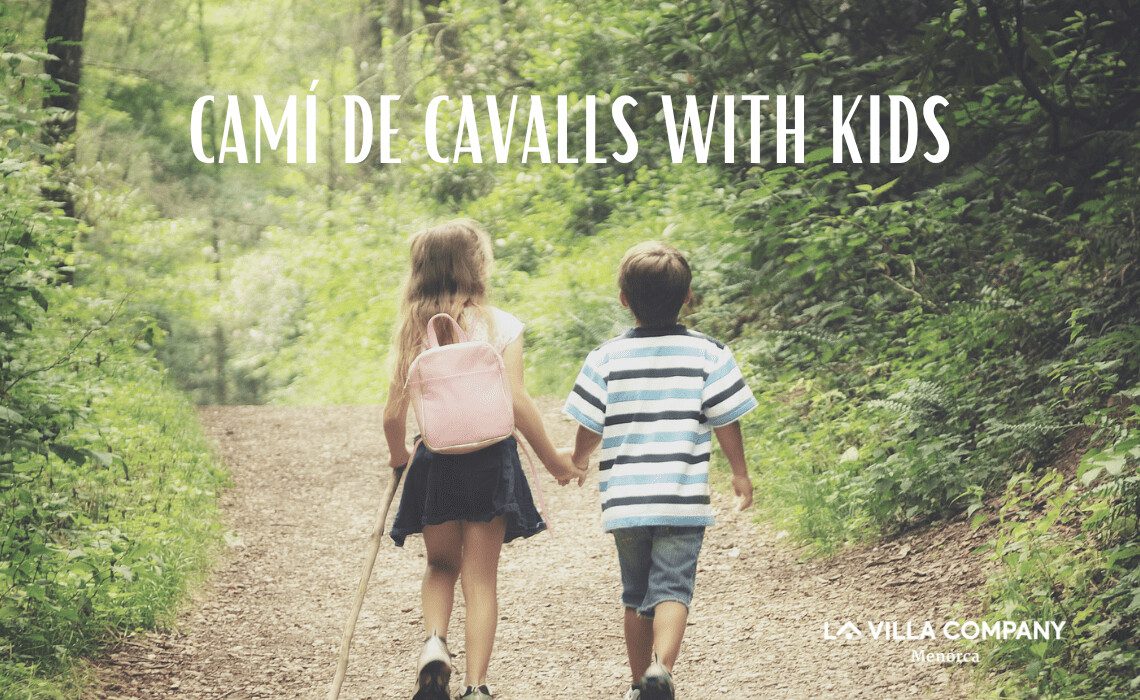 Two young children walking hand in hand on a forest trail along the Camí de Cavalls in Menorca, ideal for family adventures from nearby holiday villas.