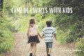Two young children walking hand in hand on a forest trail along the Camí de Cavalls in Menorca, ideal for family adventures from nearby holiday villas.