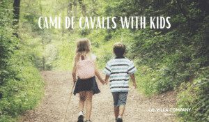 Two young children walking hand in hand on a forest trail along the Camí de Cavalls in Menorca, ideal for family adventures from nearby holiday villas.